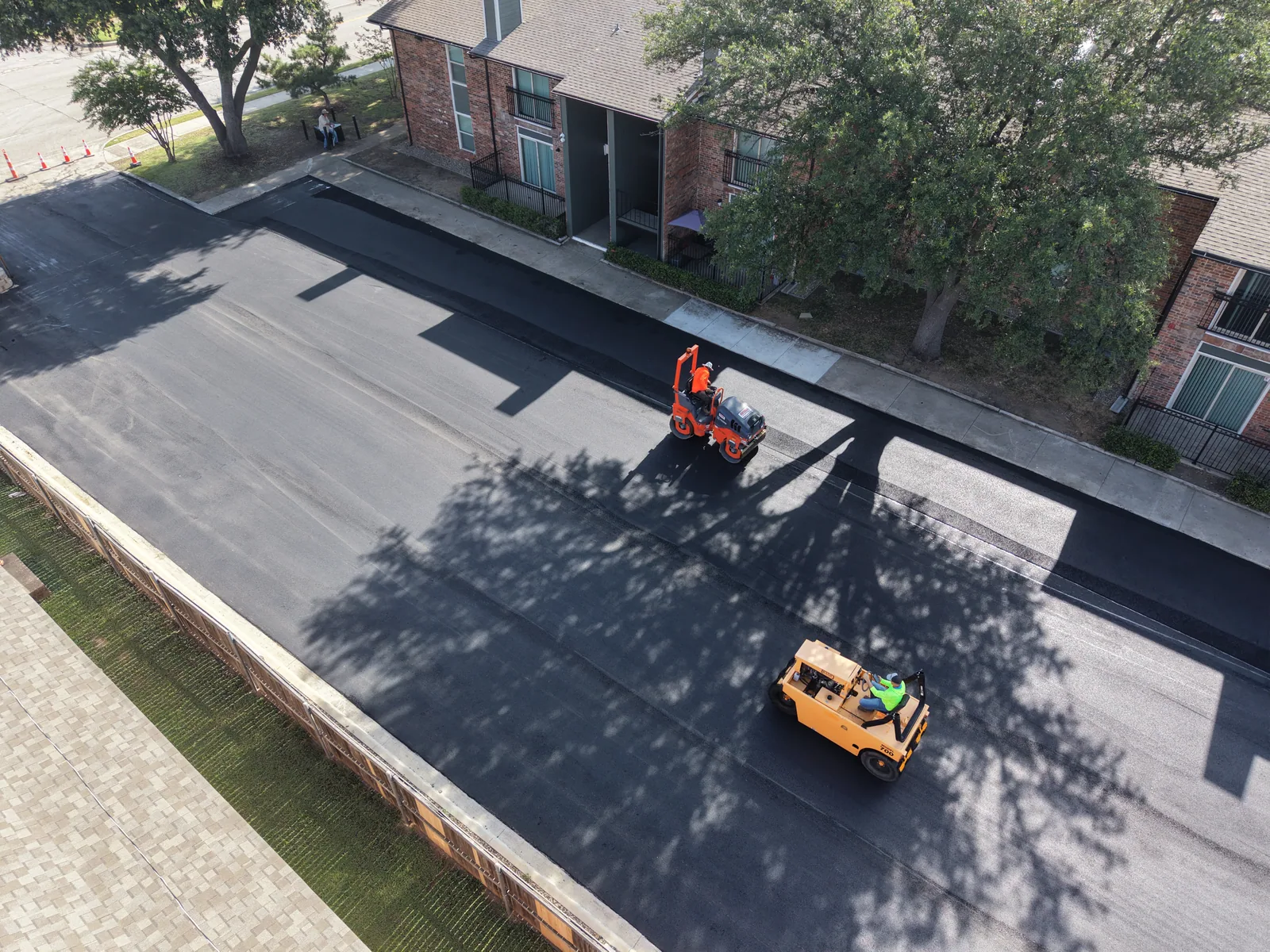 Paving and compaction equipment working on a commercial property