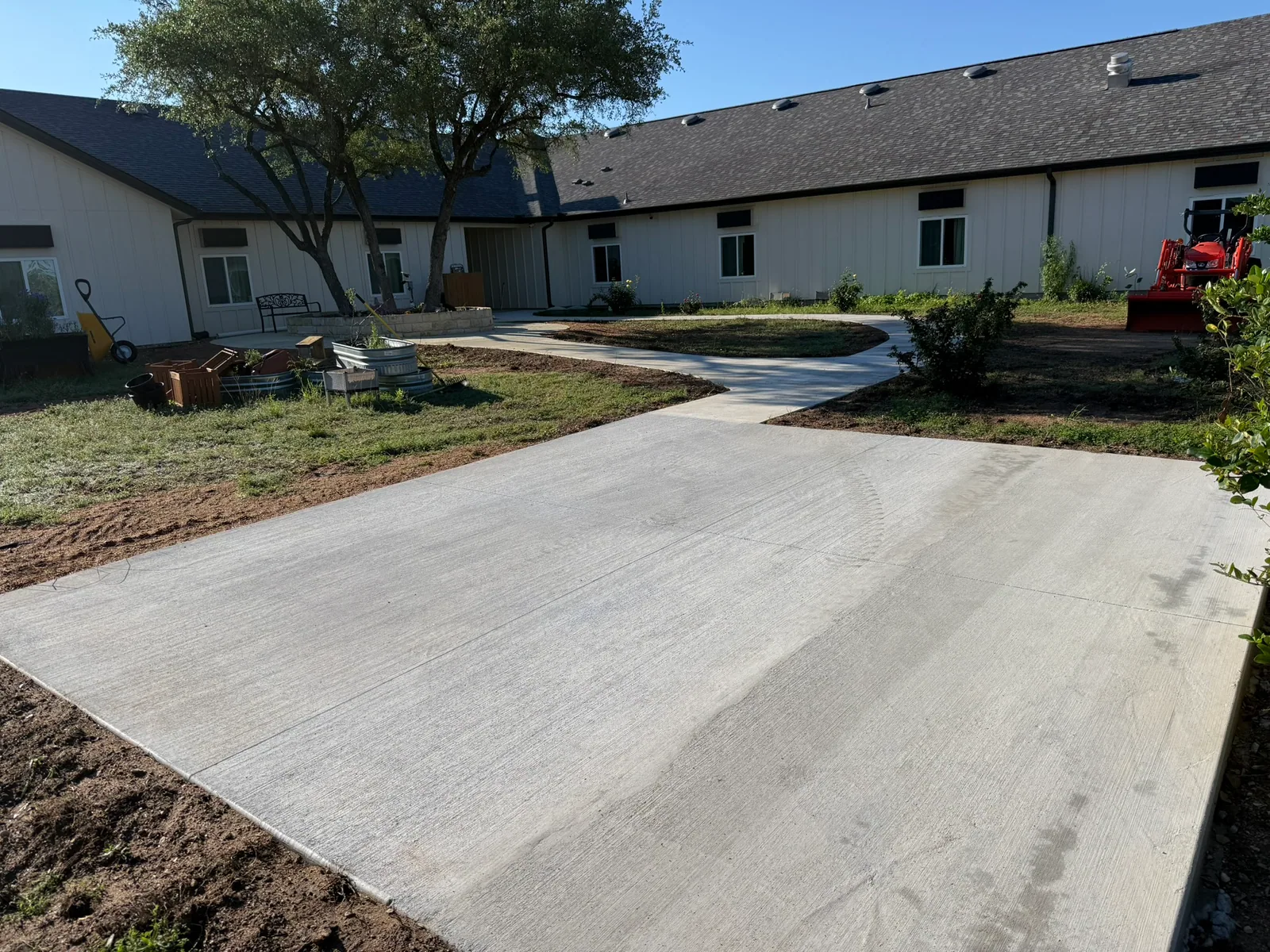 Newly placed concrete drive approach beside a commercial building